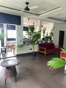 a living room with a couch and a table at Seaside Villa in Dhiffushi