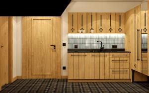 a kitchen with wooden cabinets and a sink at Ku Dolinie in Kościelisko