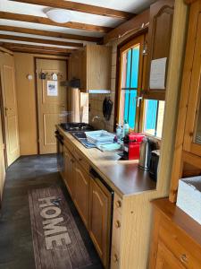 a kitchen with wooden cabinets and a counter top at Mobile home Le paradis dans la nature in Bourg-Saint-Pierre