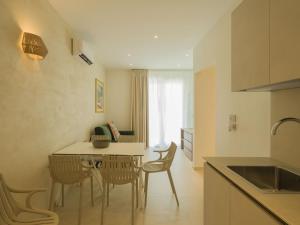 a kitchen and dining room with a table and chairs at San Vito Resort & Spa in San Vito lo Capo