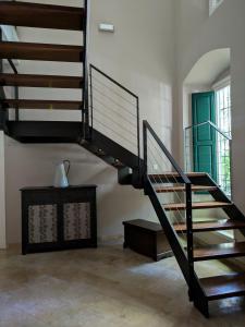 a staircase in a room with a vase on a table at Hotel del Balneario in Tolox