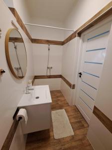 a bathroom with a sink and a mirror at Most Apartmanok in Sátoraljaújhely +11 photos
