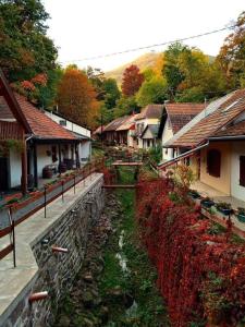 a small village with houses and a stone wall at Most Apartmanok in Sátoraljaújhely