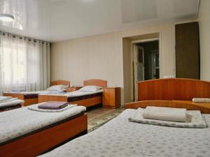 a room with four beds in a room at Sakura Guesthouse in Bishkek +36 photos