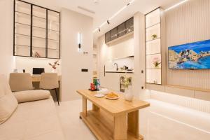 a living room with a table and a couch at NOVA HOME Apartments - NEST ONE, Panoramic Views, Tashkent City in Tashkent +263 photos