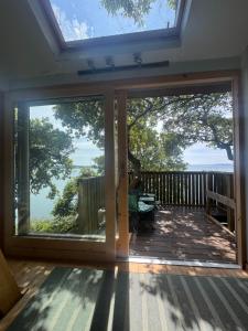 a screened porch with sliding glass doors with a view at Harbour view Tree House in Cobh