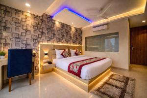 a bedroom with a large bed and a blue light at Hotel Ronit Royal - Delhi Airport in New Delhi +40 photos