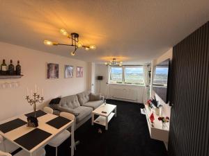 a living room with a couch and a table at Modern in Orpington