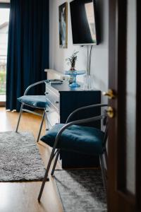 a room with two chairs and a desk with a tv at Casa Ienciu in Sibiu