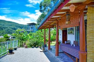 a porch of a house with a balcony at Ella Black Bridge Grand View Cottage Sri Lanka in Ella