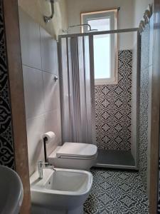 a bathroom with a toilet and a sink at Borghetto sant'irene in Erchie