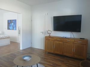 a living room with a flat screen tv on a wall at Ferien-Appartement Schröer in Nordwalde