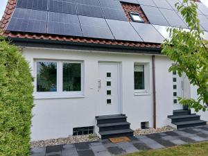 a house with solar panels on the roof at Ferien-Appartement Schröer in Nordwalde