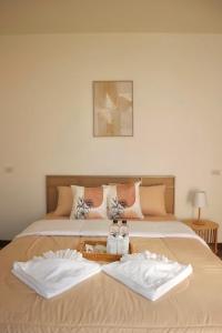 a bedroom with two beds with white towels on them at ธนาภา  +50 photos