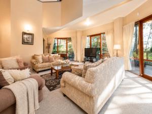 a living room with two couches and a tv at Risehill House in Kalorama