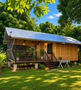 a small house with a metal roof at Thrill Playgrounds & Tipi Cafe in Libona