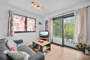 a living room with a couch and a tv at Le Petit Lu in Leysin +19 photos