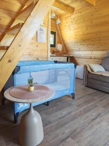 a room with a table and a couch in a cabin at Rzav A - Frames in Arilje