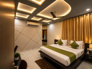 a hotel room with a bed and a ceiling at Hotel Aaradhya Residency in Agra
