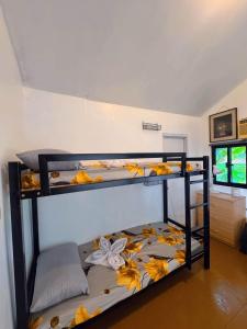 two bunk beds with leaves on them in a room at Thrill Playgrounds & Tipi Cafe in Libona