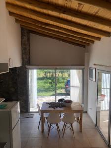 a kitchen and dining room with a table and chairs at Casa Titi in Arroyo de Los Patos