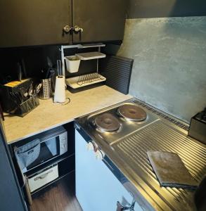 a kitchen with a stove and a counter top at Linken Studio for 2 in Narvik