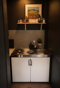a small kitchen with a sink and a stove at Linken Studio for 2 in Narvik