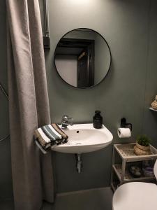 a bathroom with a white sink and a mirror at Linken Studio for 2 in Narvik +8 photos