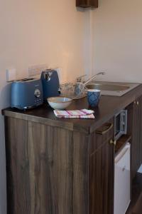 a kitchen counter with a sink and a blue appliance at Dingle Lispole Garden Suite 10 B in Lispole