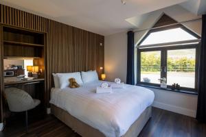 a bedroom with a large bed with a teddy bear on it at Dingle Lispole Garden Suite 10 B in Lispole