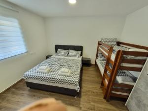 a bedroom with two bunk beds and a staircase at Komarnica Willage home in Šavnik