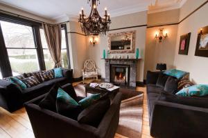 a living room with couches and a fireplace at The Grafton in Harrogate