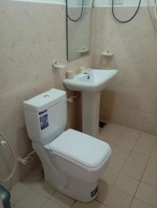a bathroom with a toilet and a sink at Larn's Villa Hotel & Apartment in Wadduwa +37 photos