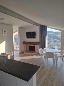 a living room with a table and a fireplace at Colle Serrano Relais & SPA in Ripatransone