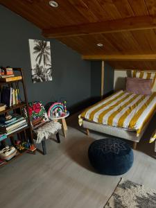 a bedroom with a bed and a chair in it at La bohème, gîte de charme in Quincié-en-Beaujolais