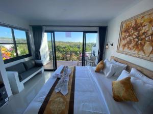 a bedroom with a large bed and a balcony at Penida Cabins in Nusa Penida