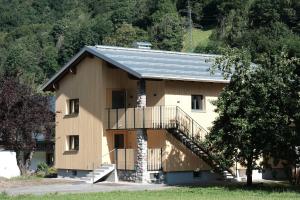 a house with a staircase in front of it at Forte Apartments in Klösterle