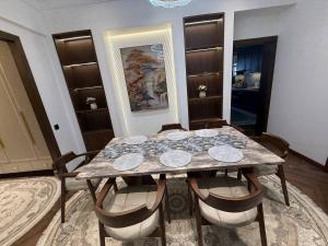 a dining room with a table and chairs at Luxury Comfort Double Room in Bukhara +1 photo