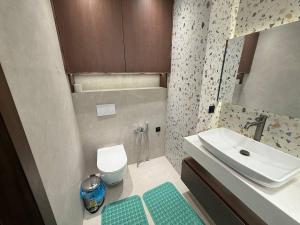 a small bathroom with a sink and a toilet at Luxury Comfort Double Room in Bukhara
