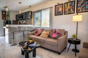 a living room with a couch and a kitchen at Bselifestyle in Green Island