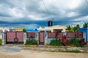 a fence in front of a house at Bselifestyle in Green Island +7 photos