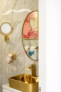 a bathroom with a gold sink and a mirror at Bselifestyle in Green Island