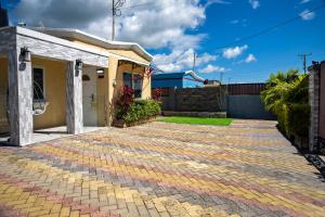 a brick driveway in front of a house at Bselifestyle in Green Island