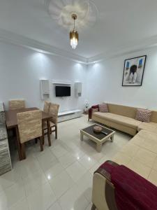 a living room with a couch and a table at Le Minaret in Kairouan