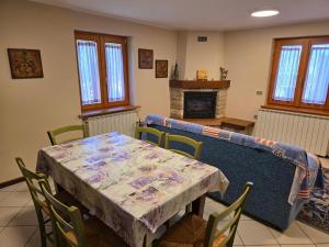 a dining room with a table with a table cloth on it at Casa con giardino e garage vicino alle piste in San Pietro