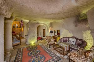 a living room with a couch and chairs at Hidden Cave Hotel in Göreme