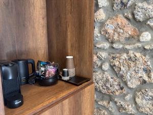 a wooden shelf with a laptop and a camera at Olympus Stone Lodge in Litochoro