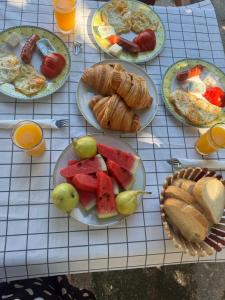 a table with plates of breakfast food on it at Welcome Guest House in Shkodër +20 photos