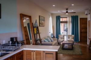 a kitchen and living room with a couch and a table at Ocean & Lighthouse view apartment in Playa Venao