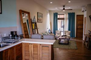 a living room with a kitchen and a living room with a couch at Ocean & Lighthouse view apartment in Playa Venao +75 photos